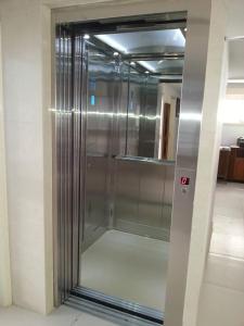 a metal elevator in a building with a mirror at La Veranda Hotel in Larnaca