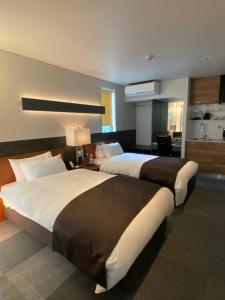 Voodi või voodid majutusasutuse Hotel 草石庵 toas