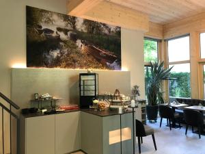 a kitchen with a large painting on the wall at Hotel Garni Villa Rosengarten in Überlingen