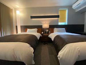 Voodi või voodid majutusasutuse Hotel 草石庵 toas