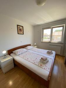 a bedroom with a large bed with two towels on it at Amela in Pula