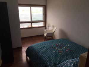 um quarto com uma cama e uma janela em Centrico. Primera linea e impresionantes vistas al mar na Corunha
