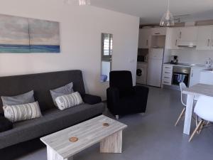 a living room with a couch and a table at Hydra Ground 1D in Puerto de Mazarrón