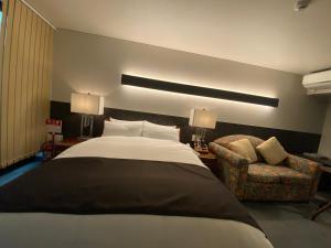 Voodi või voodid majutusasutuse Hotel 草石庵 toas