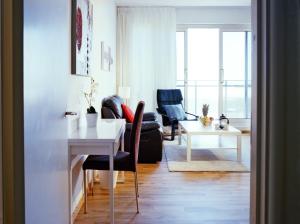 a living room with a white table and chairs at Atlantic Suites Serviced Apartments in Gibraltar