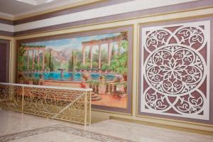 a mural in a room with a painting on the wall at "Palazzo" in Kostanay