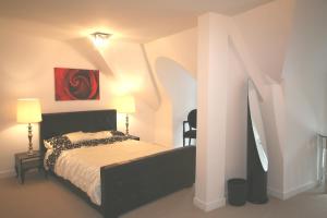 a bedroom with a bed and a painting on the wall at Tyne Bridge View in Newcastle upon Tyne