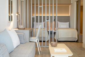 a living room with a couch and a bed at Vincci EverEden in Anavyssos