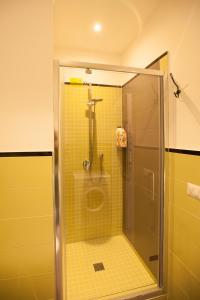 a shower with a glass door in a bathroom at BecoHouse in Rome