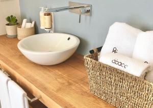 a bathroom with a bowl sink on a wooden counter at Hotel Abaco Altea in Altea