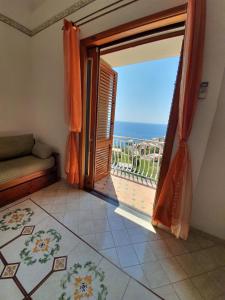 a room with an open door with a view of the ocean at Villa Celentano in Positano