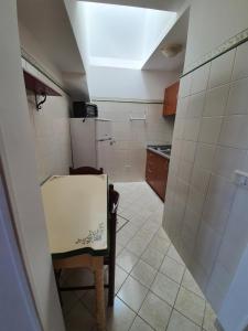 a small kitchen with a table and a refrigerator at Villa Celentano in Positano
