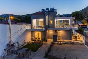 a view of a house with a patio at Yiasemi Apartments in Iraklitsa