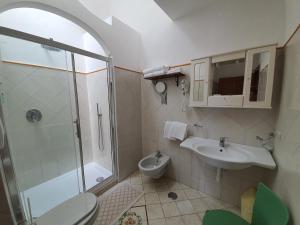 a bathroom with a shower and a toilet and a sink at Villa Celentano in Positano +15 photos