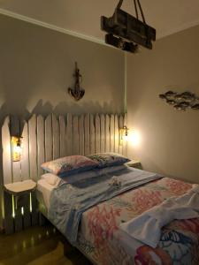 a bedroom with a large bed and a table at Helena's Rooms in Kassiopi