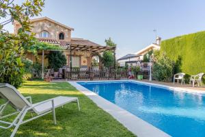 a swimming pool in the backyard of a house at Senderos de la Alhambra in La Zubia