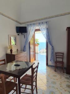 a dining room with a table and a view of the ocean at Villa Celentano in Positano