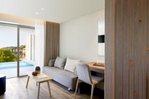 a living room with a couch and a table at Vincci EverEden in Anavyssos