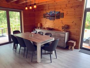 a wooden dining room with a wooden table and chairs at Chalet Colorado - jacuzzi, playstation, lakens in Durbuy