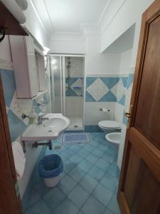 a bathroom with a sink and a toilet at Villa Celentano in Positano