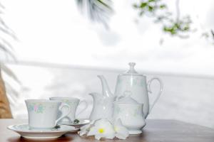 a group of white vases and cups on a table at Araliya Lagoon Park Resort in Negombo