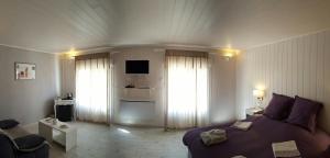 a bedroom with a bed and a living room at L Acacia in Lus-la-Croix-Haute