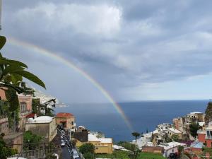 a rainbow in the sky over a city at Villa Celentano in Positano