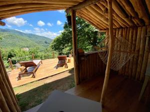 a wooden deck with a hammock and a table and chairs at B&B La Presa in Molino del Pallone