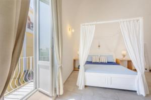 普罗奇达Le Volte Procida Home的一间带床和阳台的卧室