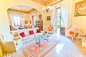 a living room with a white couch and chairs at Villa Bellavista - Tuscany panoramic view in Crespina
