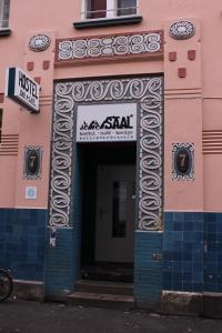 a doorway to a pink building with a sign on it at schickSAAL* in Lübeck