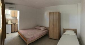 a small bedroom with a bed and a wooden cabinet at Apartments Beho in Ulcinj