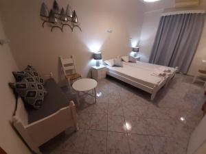 a bedroom with a bed and a table and a chair at Agia Roumeli Hotel in Agia Roumeli