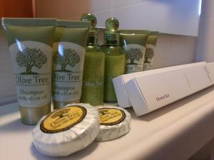 a shelf with bottles of olive tree shampoo and other products at Agia Roumeli Hotel in Agia Roumeli