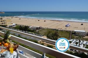 a view of the beach from the balcony of a beach resort at Hotel Santa Catarina Algarve in Portimão