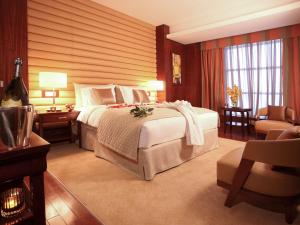 A bed or beds in a room at La Cigale Hotel Managed by Accor