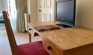 a television sitting on top of a wooden table at Ravenhill House in Belfast