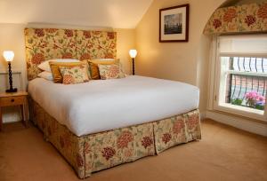 a bedroom with a large bed and a large window at Ravenhill House in Belfast