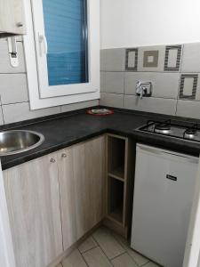 a small kitchen with a sink and a stove at Villaggio Turistico LA VESCA in Sanremo