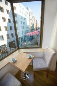 a table and a chair in a room with a window at Golden Street Hotel in Istanbul +78 photos