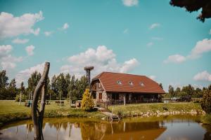 a building next to a lake with a water tower at Tindioru Holiday House in Rõuge