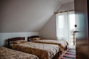 מיטה או מיטות בחדר ב-Tindioru Holiday House