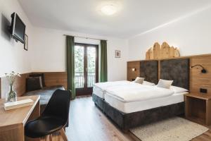 Ένα ή περισσότερα κρεβάτια σε δωμάτιο στο BergHotel Majarei