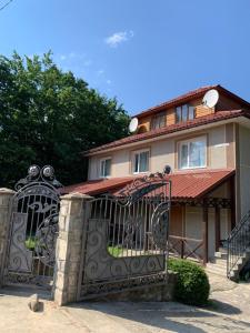 a house with a gate in front of it at Вишиванка in Sheshory