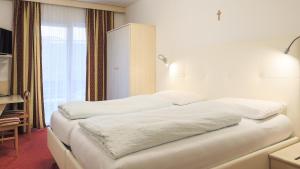 Ένα ή περισσότερα κρεβάτια σε δωμάτιο στο Hotel Markushof - Adults only