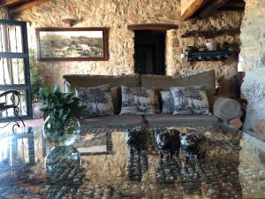 a living room with a couch and a glass table at Apartamentos Rurales La Macera **** in Valencia de Alcántara