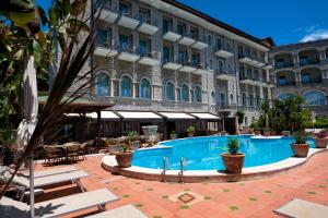 a hotel with a swimming pool in front of a building at Taormina Park Hotel in Taormina