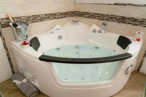 a bath tub in a corner of a bathroom at Barbarossa in Siena +10 photos