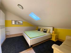 a bedroom with a bed with yellow walls at Apartments Suzi Crikvenica in Crikvenica