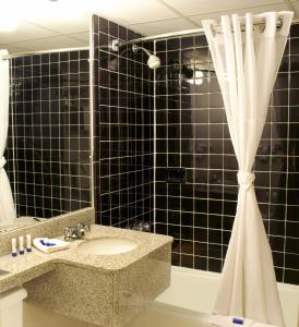 a bathroom with a sink and a shower at West Gate Inn Nyack in Nyack